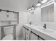 Bathroom with double sinks, sliding barn door storage, and modern lighting at 6486 Aquila Dr, Morrow, GA 30260
