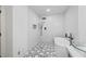 Modern bathroom showcasing a sleek, white bathtub and a stylish black and white tiled shower at 6486 Aquila Dr, Morrow, GA 30260