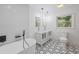 Contemporary bathroom featuring double sink vanities, soaking tub, and modern fixtures at 6486 Aquila Dr, Morrow, GA 30260