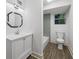 Updated bathroom features stylish mirror, white vanity, and tile shower at 6486 Aquila Dr, Morrow, GA 30260