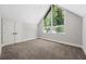 Neutral bedroom with a large triangular window and soft carpet at 6486 Aquila Dr, Morrow, GA 30260