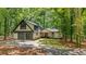 Expansive home with two car garage, black window trim and a manicured front lawn at 6486 Aquila Dr, Morrow, GA 30260