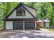 Exterior of home showing attached two-car garage with black doors and updated black trim at 6486 Aquila Dr, Morrow, GA 30260