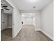 Hallway leading to a living room with vinyl floors; ceiling fan visible in room to the left at 6486 Aquila Dr, Morrow, GA 30260