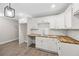 Bright kitchen featuring white cabinets, wood countertops, and stainless steel faucet at 6486 Aquila Dr, Morrow, GA 30260