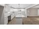 Bright kitchen features white cabinets, gray countertops, an island, and stainless steel appliances at 6486 Aquila Dr, Morrow, GA 30260