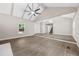 Open concept living room with vaulted ceiling, wood floors, and a view of the staircase at 6486 Aquila Dr, Morrow, GA 30260