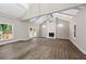 Spacious living room with vaulted ceilings, wood floors, fireplace and double doors to the backyard at 6486 Aquila Dr, Morrow, GA 30260