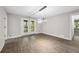 Spacious living room with doors leading to outdoor space and modern lighting fixture at 6486 Aquila Dr, Morrow, GA 30260