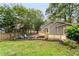 A backyard with a new wooden deck, stepping stones, a firepit, and blue Adirondack chairs at 814 S Mcdonough St, Decatur, GA 30030