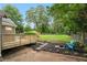 Backyard with new deck, stepping stones, firepit, blue Adirondack chairs, and a grassy area at 814 S Mcdonough St, Decatur, GA 30030