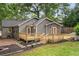 View of home's backyard with a new wooden deck and stepping stones leading to a mulched area at 814 S Mcdonough St, Decatur, GA 30030