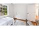 Bedroom with neutral walls, wood floors, bright windows, and cozy decor offers a welcoming retreat at 814 S Mcdonough St, Decatur, GA 30030