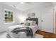 Cozy bedroom offers natural light, hardwood floors, and neutral decor at 814 S Mcdonough St, Decatur, GA 30030