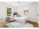 Comfortable bedroom with white walls, wooden floors, bright windows, and stylish decor provides a cozy retreat at 814 S Mcdonough St, Decatur, GA 30030