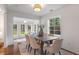 Sunlit dining room features modern light fixture, stylish seating for six, and bright sunlight at 814 S Mcdonough St, Decatur, GA 30030