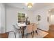 Cozy dining room with modern light fixture, stylish seating for six, and a view of the outdoors at 814 S Mcdonough St, Decatur, GA 30030