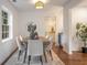 Bright dining area with modern light fixture, stylish seating for six, and a view of the kitchen at 814 S Mcdonough St, Decatur, GA 30030