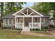 Charming gray home features a welcoming front porch with a swing, complemented by a well-manicured lawn at 814 S Mcdonough St, Decatur, GA 30030
