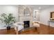 Bright living room boasts a decorative brick fireplace, hardwood floors, and stylish, comfortable seating at 814 S Mcdonough St, Decatur, GA 30030