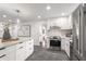 Kitchen with stainless appliances, white cabinetry, eat-in island, and tile backsplash at 814 S Mcdonough St, Decatur, GA 30030