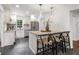 Bright kitchen features white cabinets, stainless steel appliances, and eat-in kitchen island at 814 S Mcdonough St, Decatur, GA 30030