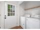 Bright laundry room features modern washer and dryer units, shelving, and a door to the exterior at 814 S Mcdonough St, Decatur, GA 30030