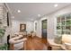 Sunlit living room features hardwood floors, a decorative fireplace, comfortable seating, and ample natural light at 814 S Mcdonough St, Decatur, GA 30030