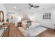Bright main bedroom with a ceiling fan, hardwood floors, stylish decor, and a hallway leading to other rooms at 814 S Mcdonough St, Decatur, GA 30030