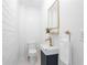 Stylish powder room featuring white brick walls, a unique sink, and modern fixtures creates a chic design at 814 S Mcdonough St, Decatur, GA 30030