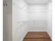 Walk-in closet with custom shelving is a practical storage solution with durable wooden floors at 814 S Mcdonough St, Decatur, GA 30030