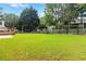 Expansive backyard featuring a well-kept lawn, mature trees, and a classic picket fence at 11885 Carriage Park Ln, Duluth, GA 30097