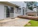Cozy backyard with a concrete patio, small deck, bay window, and sliding glass door at 11885 Carriage Park Ln, Duluth, GA 30097