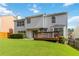 This is a beautiful backyard with a deck and a sliding glass door with a well maintained lawn at 11885 Carriage Park Ln, Duluth, GA 30097