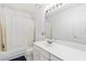 Bathroom with a tub and shower combo, a vanity, and a large mirror at 11885 Carriage Park Ln, Duluth, GA 30097