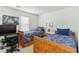 Bedroom with two wooden beds and a window, plus some decorations at 11885 Carriage Park Ln, Duluth, GA 30097