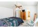 A bedroom features a four-poster bed, a ceiling fan, and a wooden cabinet at 11885 Carriage Park Ln, Duluth, GA 30097