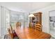 Dining room with large bay window, wood table, and a view into the kitchen at 11885 Carriage Park Ln, Duluth, GA 30097
