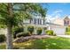 Two story home with well-maintained lawn, featuring brick and siding accents at 11885 Carriage Park Ln, Duluth, GA 30097