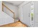 Inviting foyer with wood floors and a staircase, next to the home's front door at 11885 Carriage Park Ln, Duluth, GA 30097
