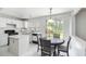 Bright kitchen and breakfast nook features white cabinets, black appliances, and sliding glass doors at 11885 Carriage Park Ln, Duluth, GA 30097