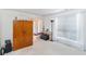 Bright living room with large window, wood cabinet and view to the home's entrance at 11885 Carriage Park Ln, Duluth, GA 30097