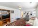 Inviting living room with a large window, TV, ceiling fan and view to the kitchen at 11885 Carriage Park Ln, Duluth, GA 30097