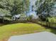Large, grassy backyard enclosed by a wooden fence and mature trees at 1904 Watercrest Cir, Lawrenceville, GA 30043