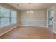 Light-filled dining room with hardwood floors, chandelier, and large windows at 1904 Watercrest Cir, Lawrenceville, GA 30043