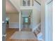 Bright entryway with wood floors, staircase, and views into the living spaces at 1904 Watercrest Cir, Lawrenceville, GA 30043