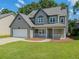 Charming two-story home with a well-manicured lawn and a welcoming front porch and attached garage at 1904 Watercrest Cir, Lawrenceville, GA 30043
