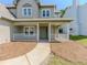 Inviting covered front porch features a walkway and decorative columns at 1904 Watercrest Cir, Lawrenceville, GA 30043