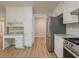 Open kitchen view featuring stainless steel refrigerator and gas range with modern cabinetry at 1904 Watercrest Cir, Lawrenceville, GA 30043