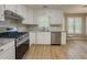 Updated kitchen boasts stainless steel appliances, granite countertops, and white cabinetry at 1904 Watercrest Cir, Lawrenceville, GA 30043